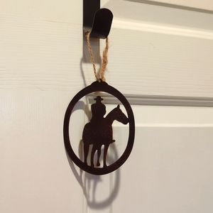 Metal cowboy on horse ornament
